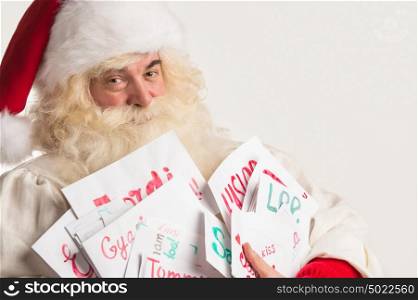 Santa Claus holding heap of letters