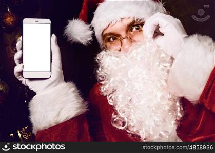 Santa Claus holding smartphone. Santa Claus holding smartphone with white blank screen in hand