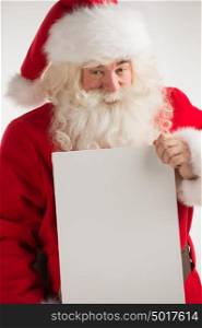Santa Claus holding white blank sign with smile