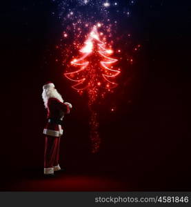 Santa Claus. Image of Santa Claus in red costume with christmas tree