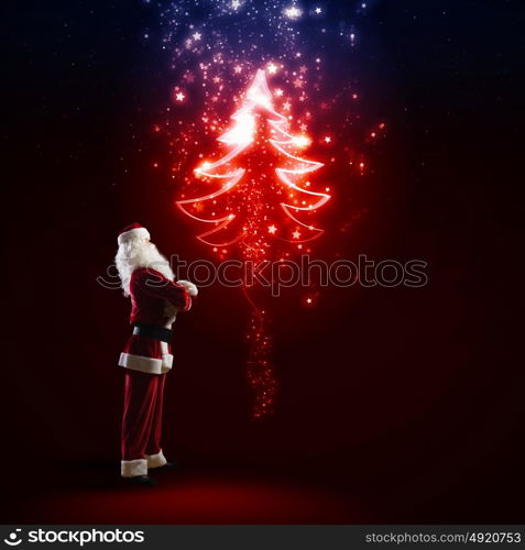 Santa Claus. Image of Santa Claus in red costume with christmas tree