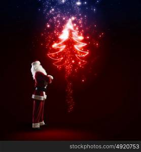 Santa Claus. Image of Santa Claus in red costume with christmas tree