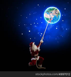 Santa Claus. Image of Santa Claus in red costume with Earth planet