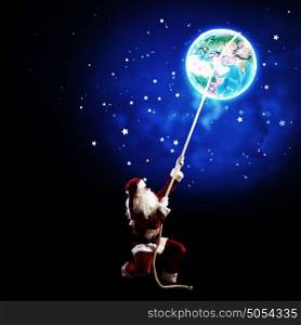 Santa Claus. Image of Santa Claus in red costume with Earth planet
