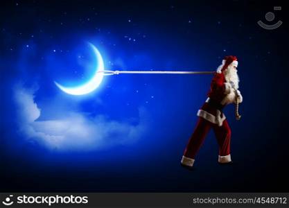 Santa Claus. Image of Santa Claus pulling moon with rope