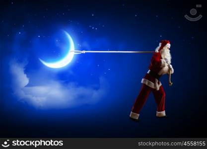 Santa Claus. Image of Santa Claus pulling moon with rope