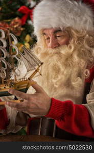 Santa Claus in his workshop making new toys for Christmas Presents for children around the world