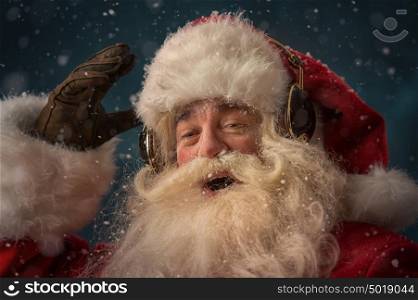 Santa Claus is listening to music in headphones wearing sunglasses. Christmas.