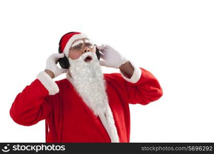 Santa Claus listening to music over white background