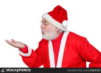 Santa Claus magically blowing in the palm of his hand isolated on white background