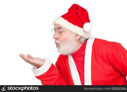 Santa Claus magically blowing in the palm of his hand isolated on white background