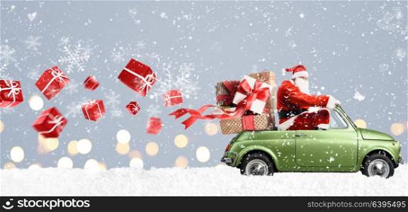Santa Claus on car. Santa Claus on car delivering Christmas or New Year gifts at snowy gray background