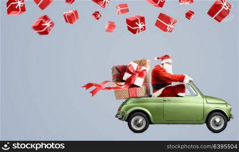 Santa Claus on car. Santa Claus on car delivering Christmas or New Year gifts at gray background