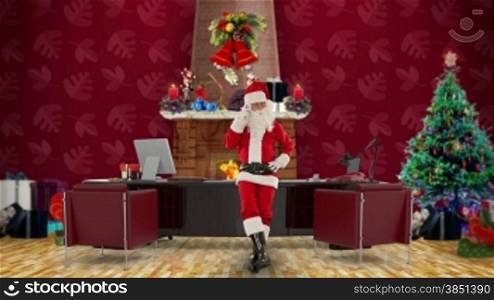 Santa Claus on mobile in his modern Christmas Office