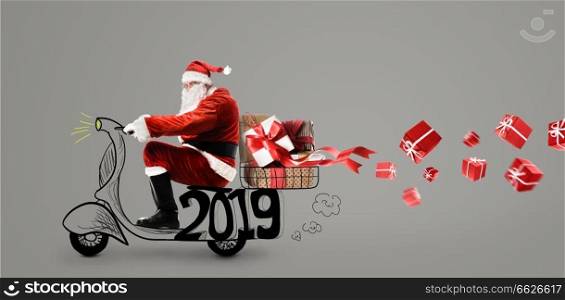 Santa Claus on scooter delivering Christmas or New Year 2019 gifts at gray background. Santa Claus on scooter