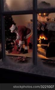 Santa Claus Putting Presents Under Christmas Tree