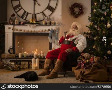 Santa Claus Resting at Home near Christmas Tree