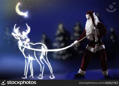 Santa Claus. Santa Claus and christmas deer on lace