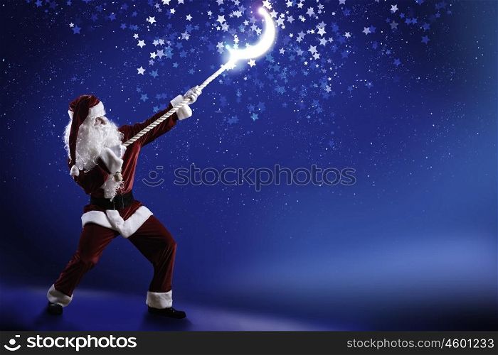 Santa Claus. Santa Claus catching moon in night sky with rope