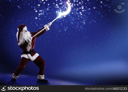Santa Claus. Santa Claus catching moon in night sky with rope