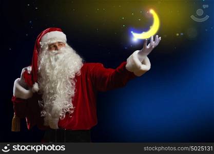 Santa Claus. Santa Claus holding shining moon in palm