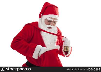 Santa Claus searching for something in bag white standing over white background