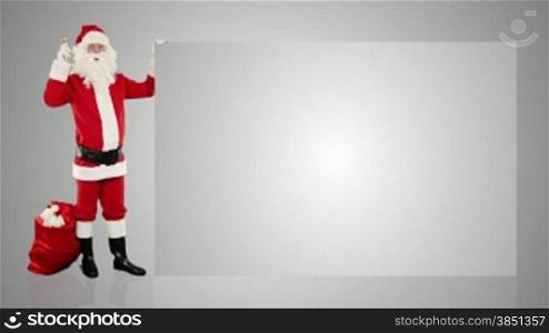 Santa Claus shaking bell presenting a white sheet