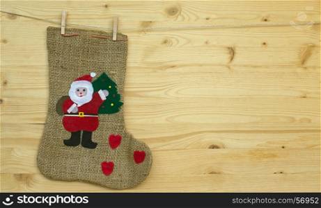 santa claus sock or stocking with clothes pegs on wood