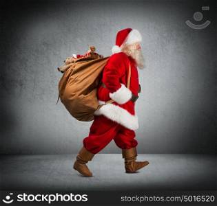 Santa Claus walking with the bag of the presents