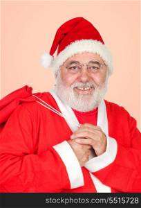 Santa Claus with a full sack isolated on a orange background
