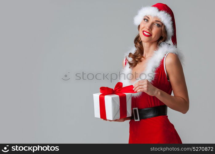 Santa Claus woman with gift. Beautiful woman in Santa Claus style dress with gift box