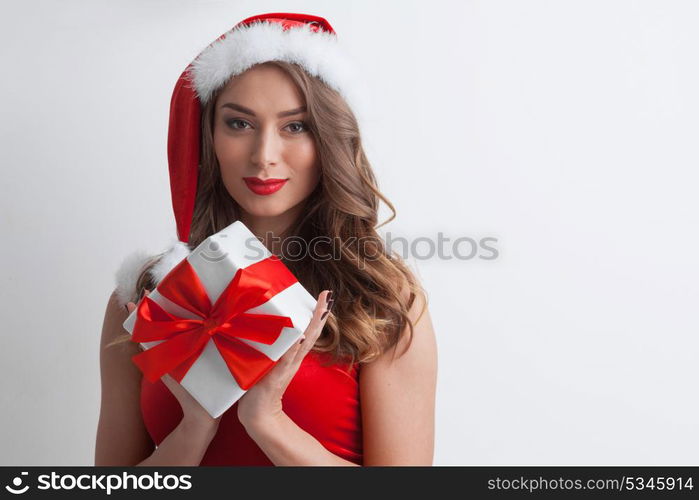 Santa Claus woman with gift. Beautiful woman in Santa Claus style dress with gift box