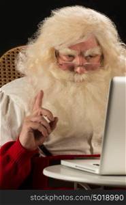 Santa Claus working on computer and having great idea. Idea gesture