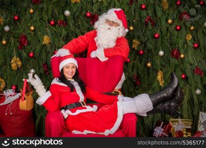 Santa Clause woman sitting on Christmas armchair present decoration