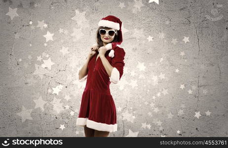 Santa Girl. Attractive young girl in Santa suit against color background