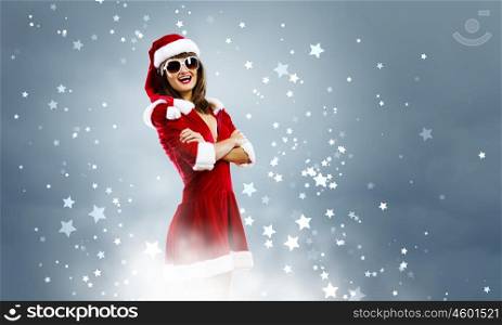 Santa Girl. Attractive young girl in Santa suit against color background