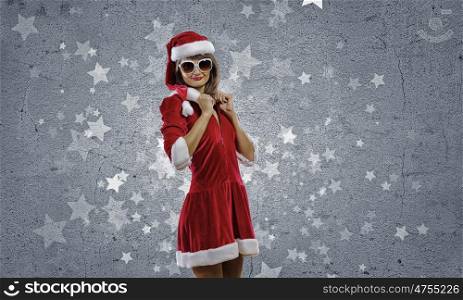 Santa Girl. Attractive young girl in Santa suit against color background