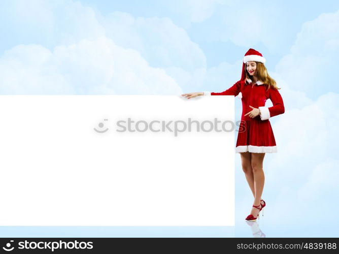 Santa girl. Girl in Santa costume with white blank banner. Place for text