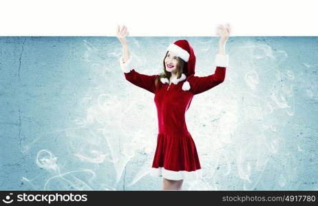 Santa girl. Girl in Santa costume with white blank banner. Place for text