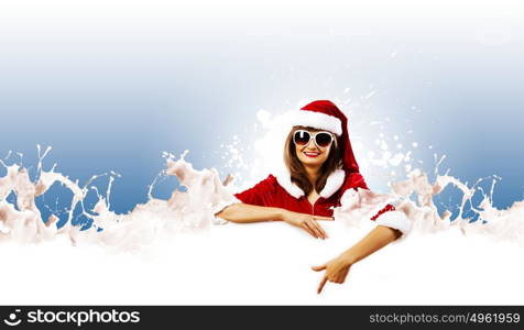 Santa girl. Girl in Santa costume with white blank banner. Place for text