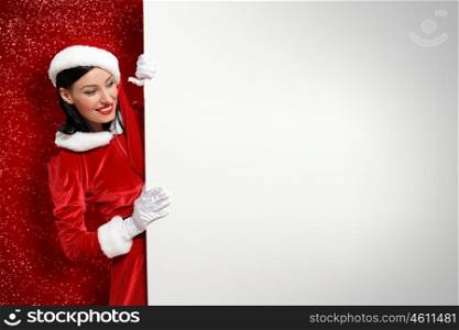 santa girl with a blank banner. Portrait of a santa girl with a blank banner