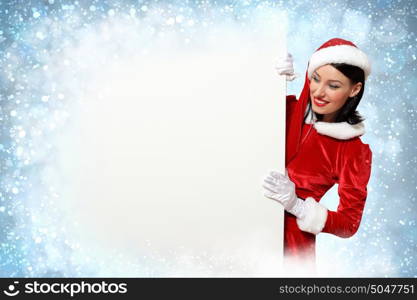 santa girl with a blank banner. Portrait of a santa girl with a blank banner