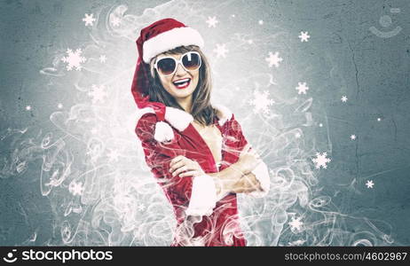 Santa girl. Young attractive woman in santa suit and sunglasses