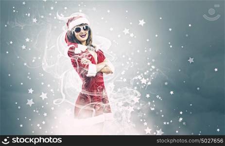 Santa girl. Young attractive woman in santa suit and sunglasses