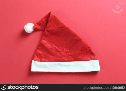 Santa hat on red art paper background for design in Christmas and New Year&rsquo;s concept.