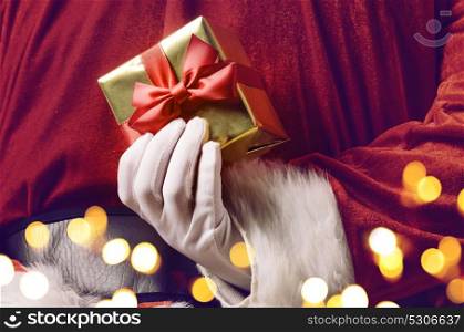 Santa hiding surprise. Santa Claus holding Christmas or New Year gift behind his back