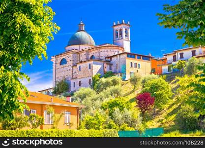 Santa Maria della Neve church on idyllic green hill, Raffa village, Lago di Garda, Italy