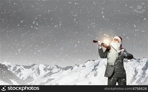 Santa play violin. Businessman in Santa hat and beard playing violin