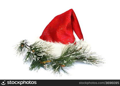 Santa&rsquo;s red hat and fir tree branch isolated on white background.