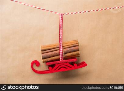 Santa's fairy Christmas decorative sleigh hanging on a ribbon. Old brown paper background